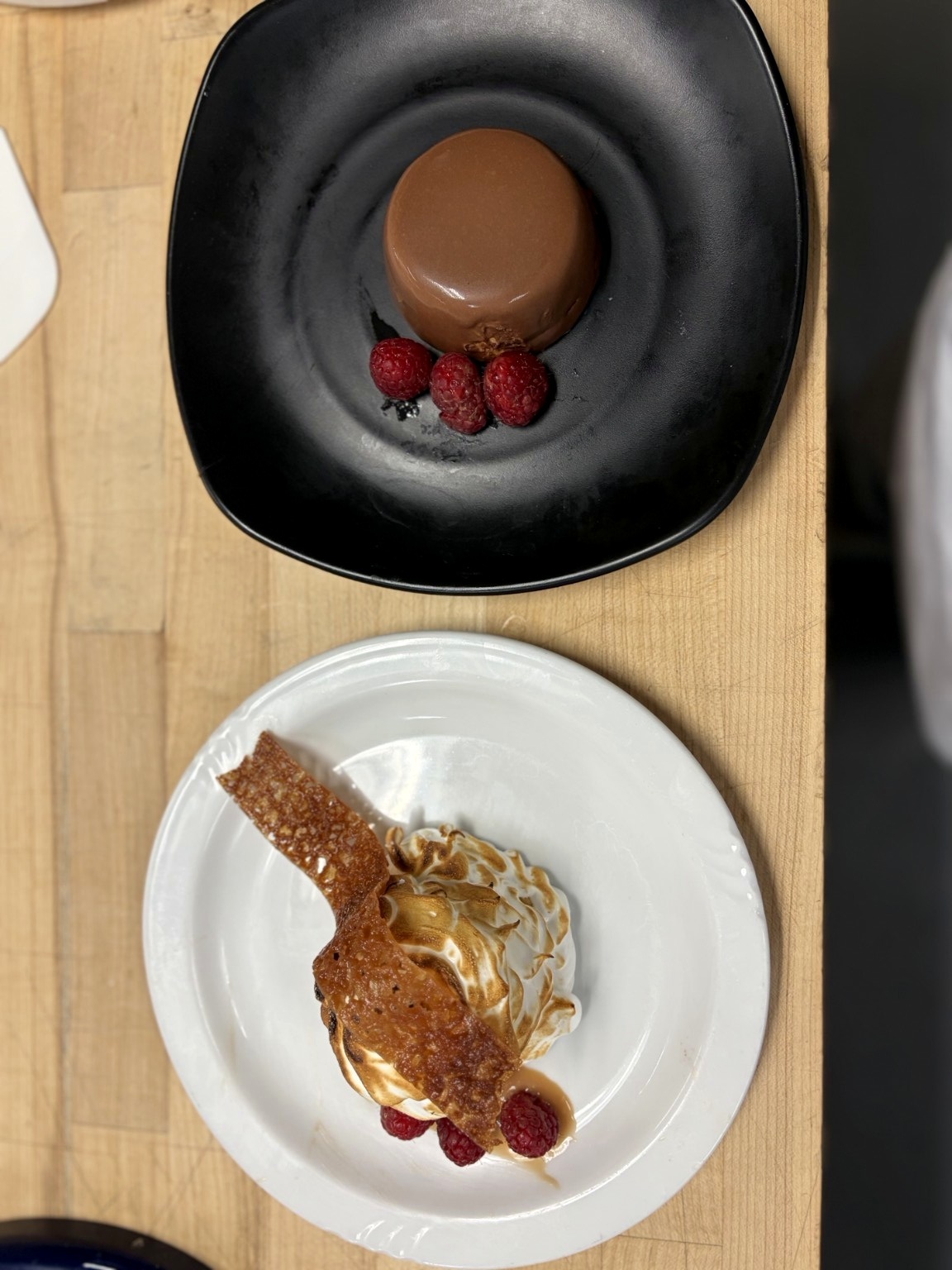 Molded chocolate dessert with raspberries